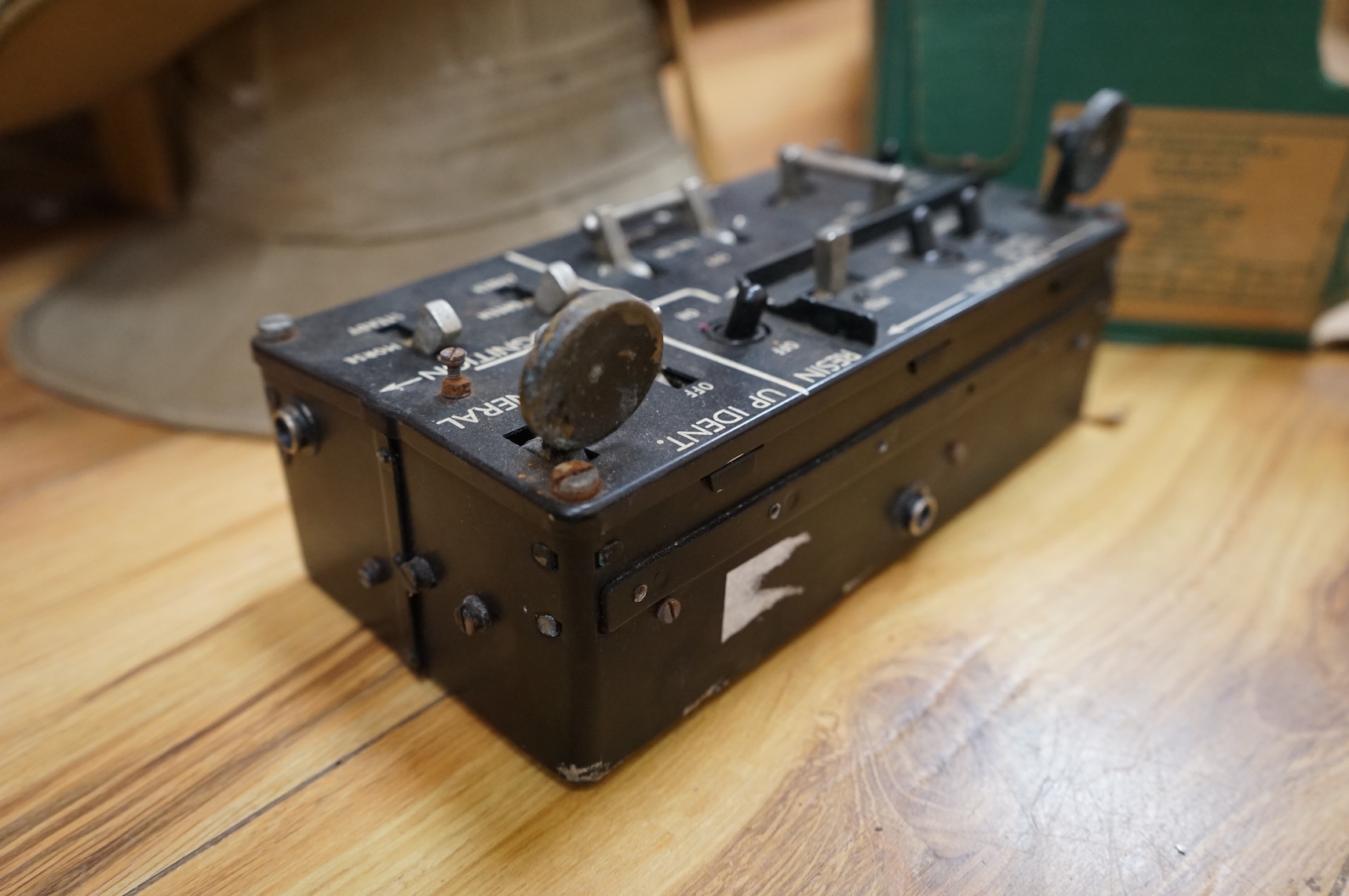 A collection of military related items, including an instrument panel from a WWII RAF Lancaster bomber aircraft, a Bosun’s whistle, a Heckler and Koch ‘bullet’ pen, a WWII tin hat (possibly police), a pith helmet, an Aus